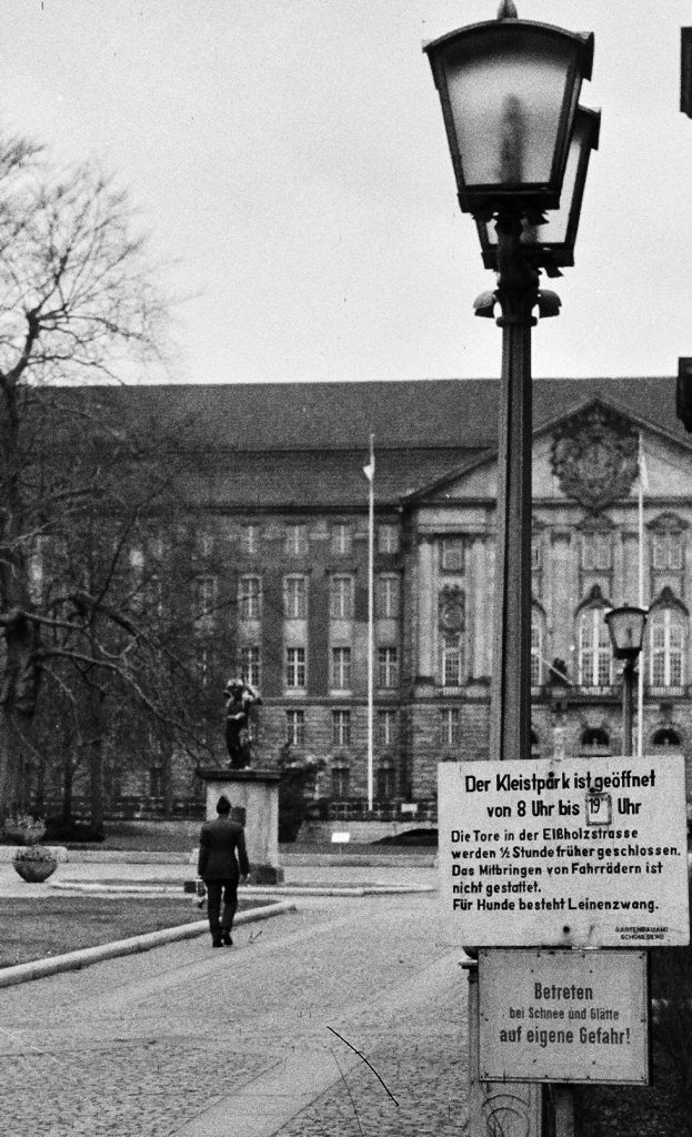 Photographer walks toward the Allied Control Authority Building.