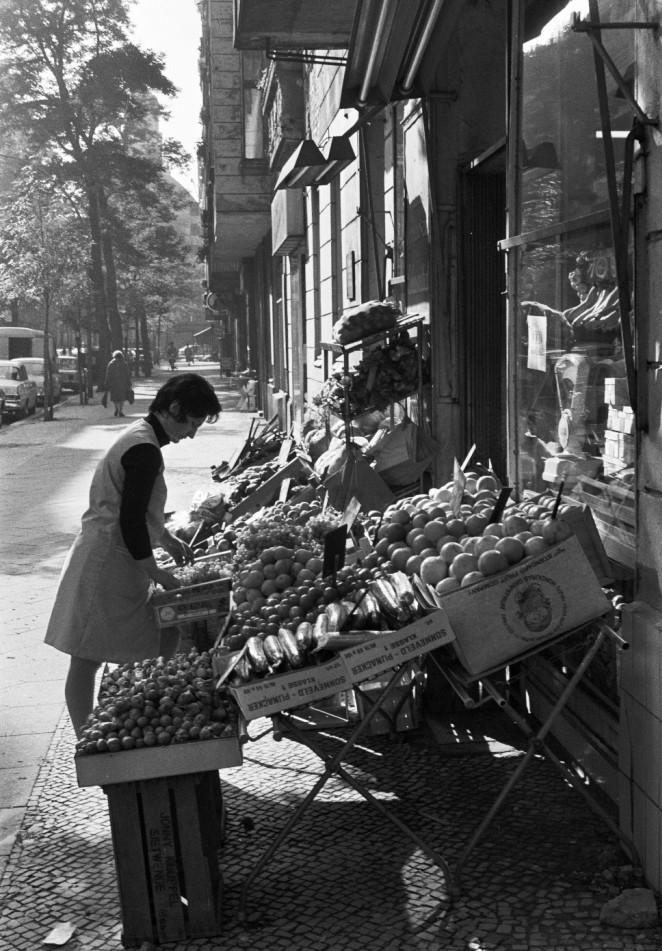 Grocer lays out her goods.