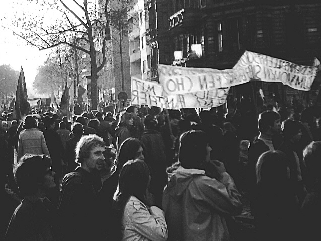 Marchers gather in bright sunlight.